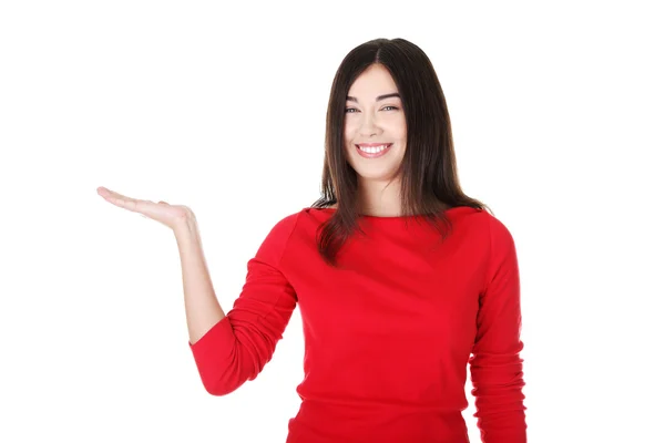 Excited young woman presenting copy space — Stock Photo, Image
