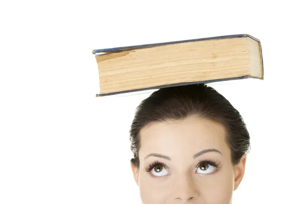 Attractive woman with book on head — Stock Photo, Image