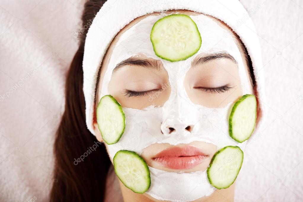 Woman with cucumber slices on the face