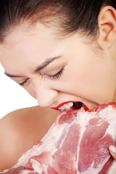 Young beautiful woman eating raw meat. — Stok fotoğraf