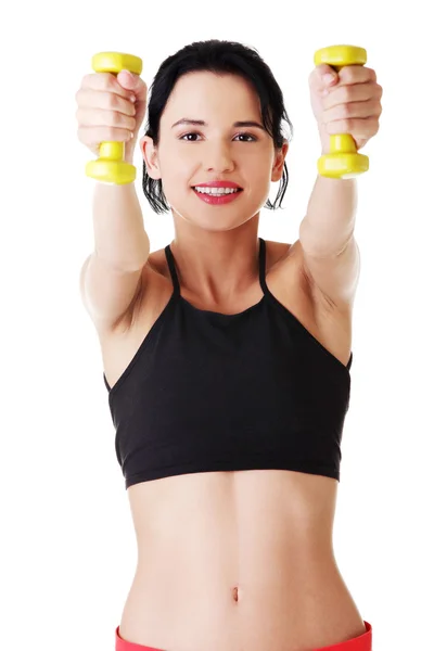 Chica de fitness está trabajando con pesas —  Fotos de Stock