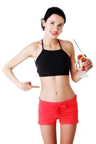 Pretty fit woman eating fruit salad — Stock Photo, Image