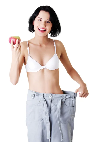 Young woman showing how much weight did she lost. — Stock Photo, Image