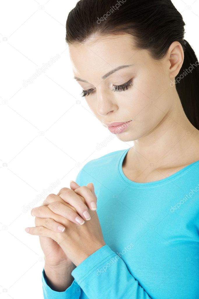 Closeup portrait of a young caucasian woman praying