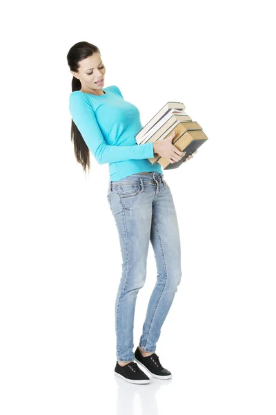 Student vrouw bedrijf zware boeken — Stockfoto