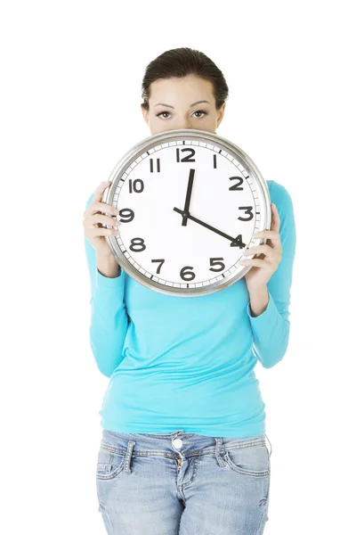 Shocked woman holding office clock — Stock Photo, Image