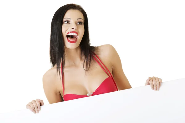 Summer girl in bikini holding blank board — Stock Photo, Image