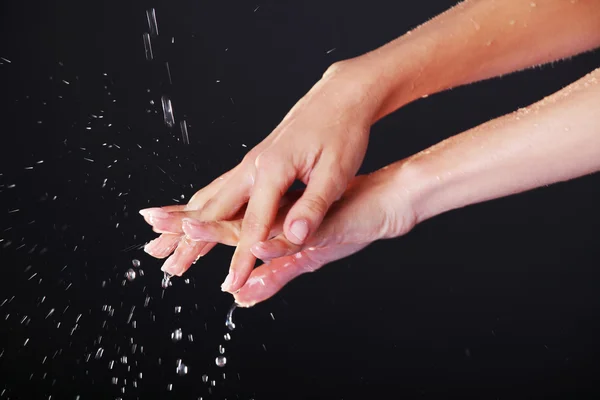 Water falling on female hands — Stock Photo, Image