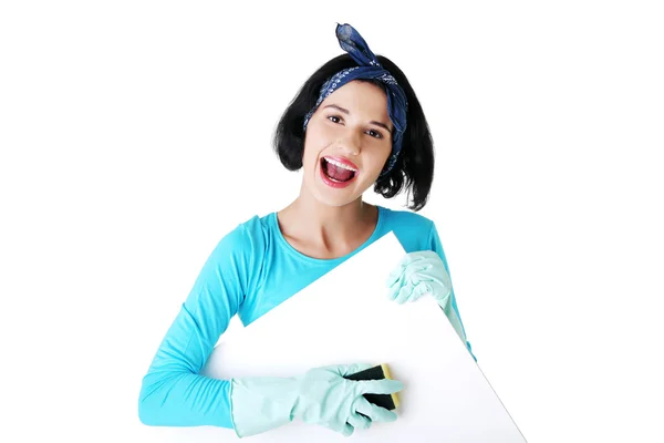 Happy cleaning woman showing blank sign board. — Stock Photo, Image