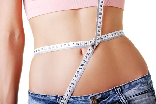 Young woman measuring her waist — Stock Photo, Image