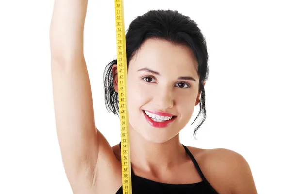 Pretty smiling woman holding measurement type. — Stock Photo, Image