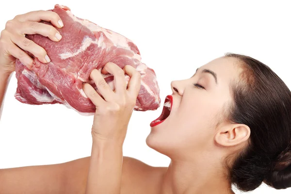 Young beautiful woman eating raw meat. — Stok fotoğraf