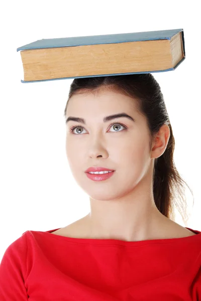 Young caucasian woman with book on her head — Stock Photo, Image