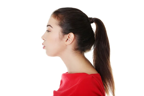 Young woman blowing on something — Stock Photo, Image