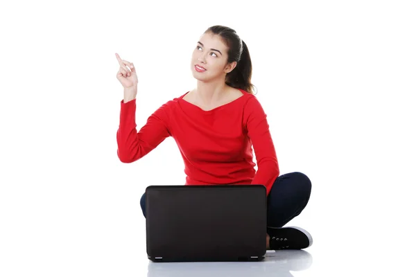 Working on laptop computer and pointing up — Stock Photo, Image
