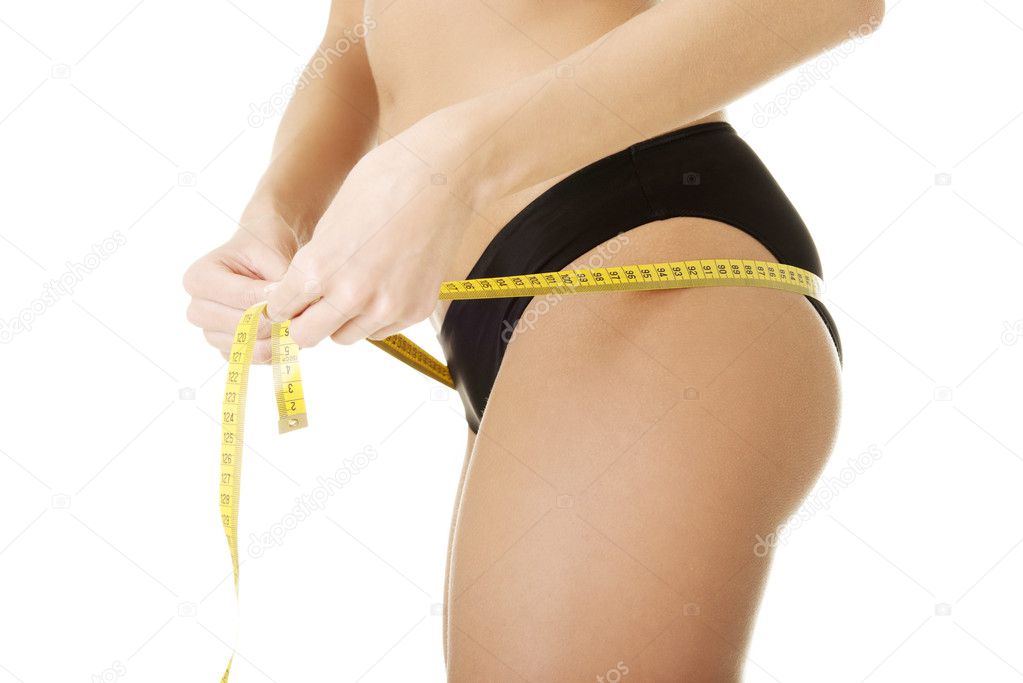Female buttocks with a measurement tape.