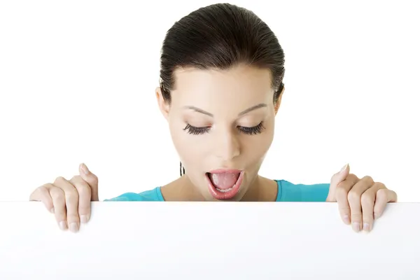 Shocked woman holding blank board — Stock Photo, Image