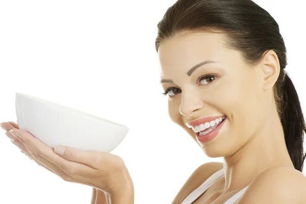 Attractive fit woman holding white bowl — Stock Photo, Image