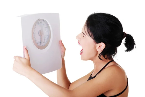 Frustrated woman with scale — Stock Photo, Image