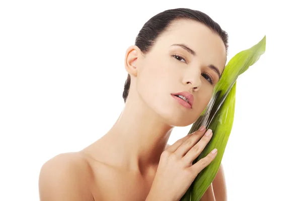 Beautiful woman with green exotic leaf — Stock Photo, Image