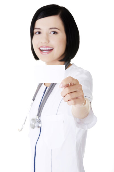 Woman doctor or nurse holding business card