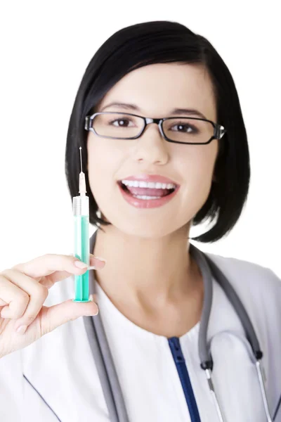 Young happy doctor or nurse holding syringe Stock Picture