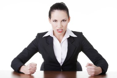 Angry businesswoman at the desk