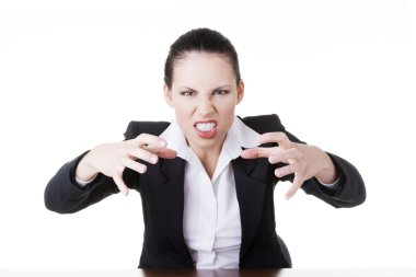 Angry businesswoman at the desk