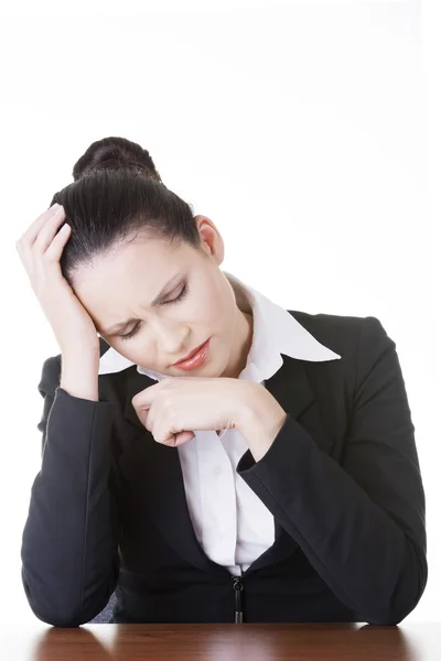 Sad business woman sitting behind the desk — Stock Photo, Image