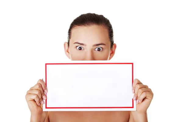 Shocked woman holding blank board — Stock Photo, Image