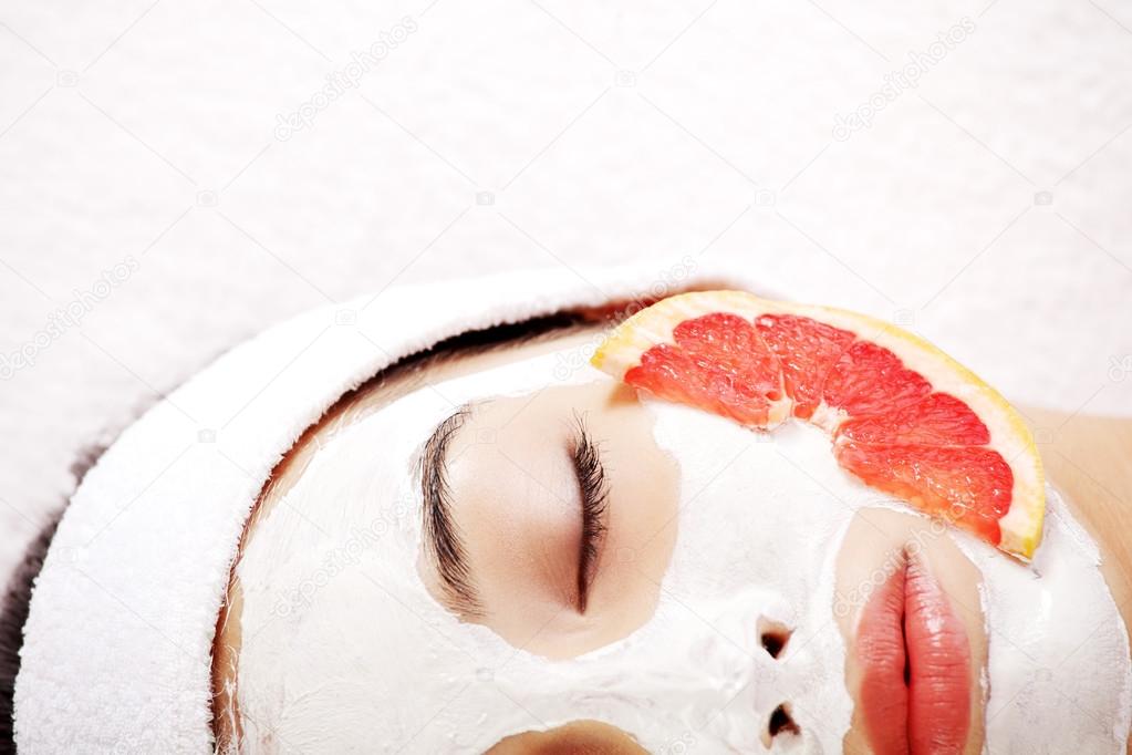 Attractive young woman with fruit mask