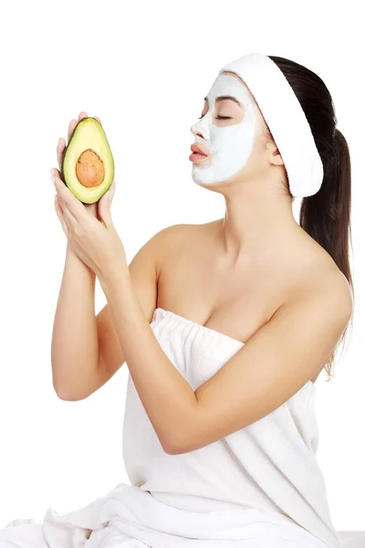 Young woman holding avocado — Stock Photo, Image