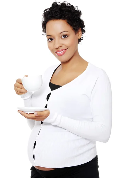 Young pregnant woman drinks cafe or tea — Stock Photo, Image