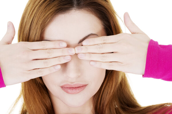 Woman covering eyes with her hands