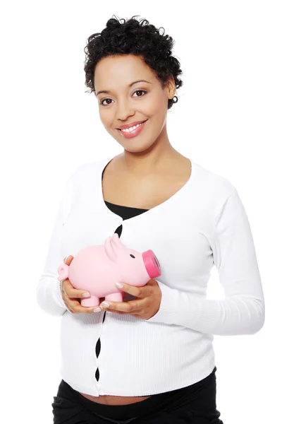 Pregnant woman holding piggy bank — Stock Photo, Image