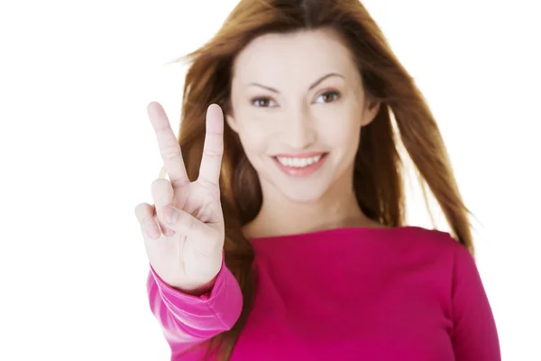 Woman showing victory sign — Stock Photo, Image