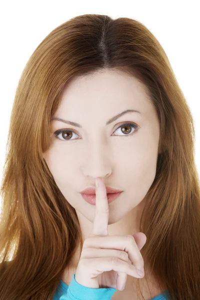 Frau mit Finger auf den Lippen. — Stockfoto