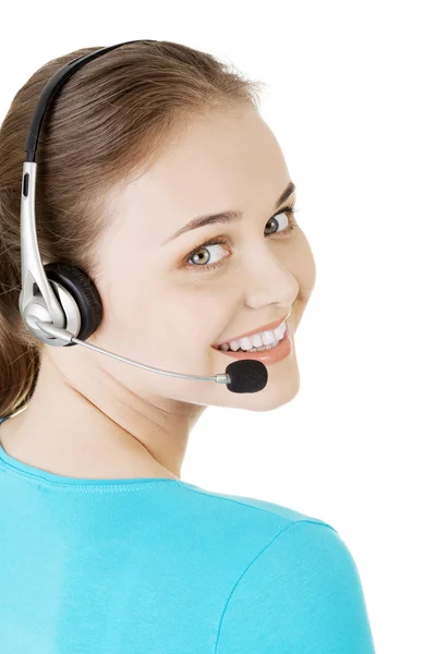 Bonito jovem assistente de call center sorrindo — Fotografia de Stock