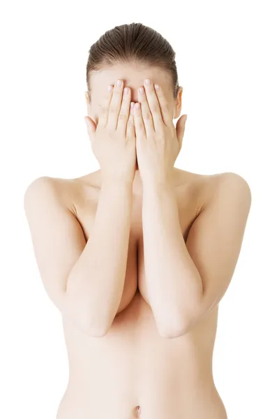 Nude woman with healthy clean skin covering face with hands — Stock Photo, Image