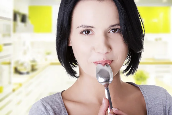 Young smiling woman with spoon — Stock Photo, Image