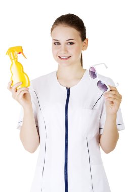 Doctor or nurse showing sunscreen and sun glasses clipart