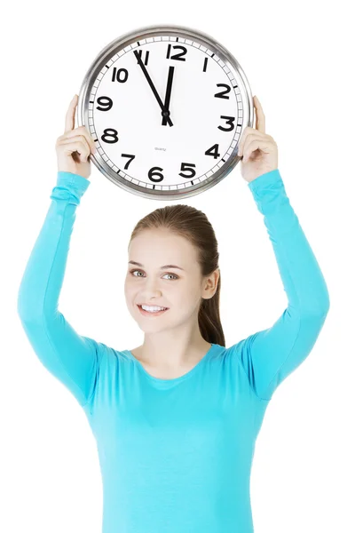 Happy young woman holding office clock — Stock Photo, Image