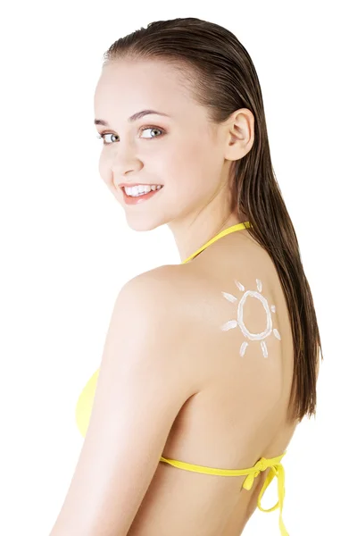 Attractive woman with sun-shaped sun cream on body. — Stock Photo, Image