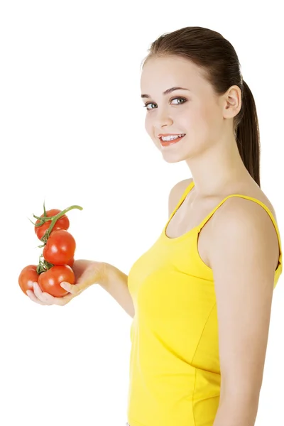 Young woman with tomato. — Stock Photo, Image