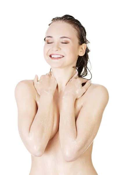 Young fit woman washing her body — Stok fotoğraf