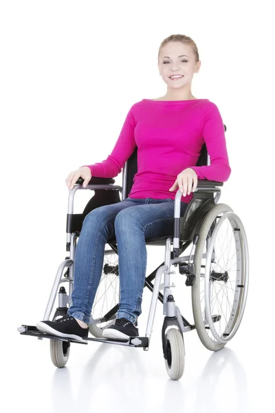 Attractive smiling disabled woman sitting in a wheel chair — Stock Photo, Image