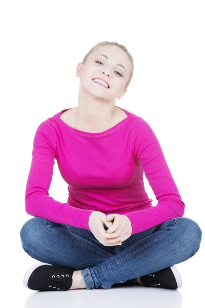 Yong happy casual woman sitting on floor — Stock Photo, Image