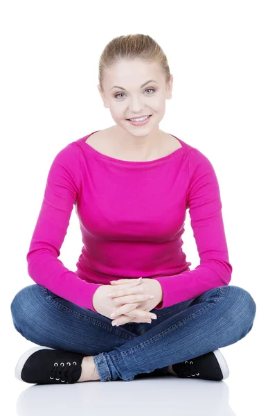 Yong happy casual woman sitting on floor — Stock Photo, Image