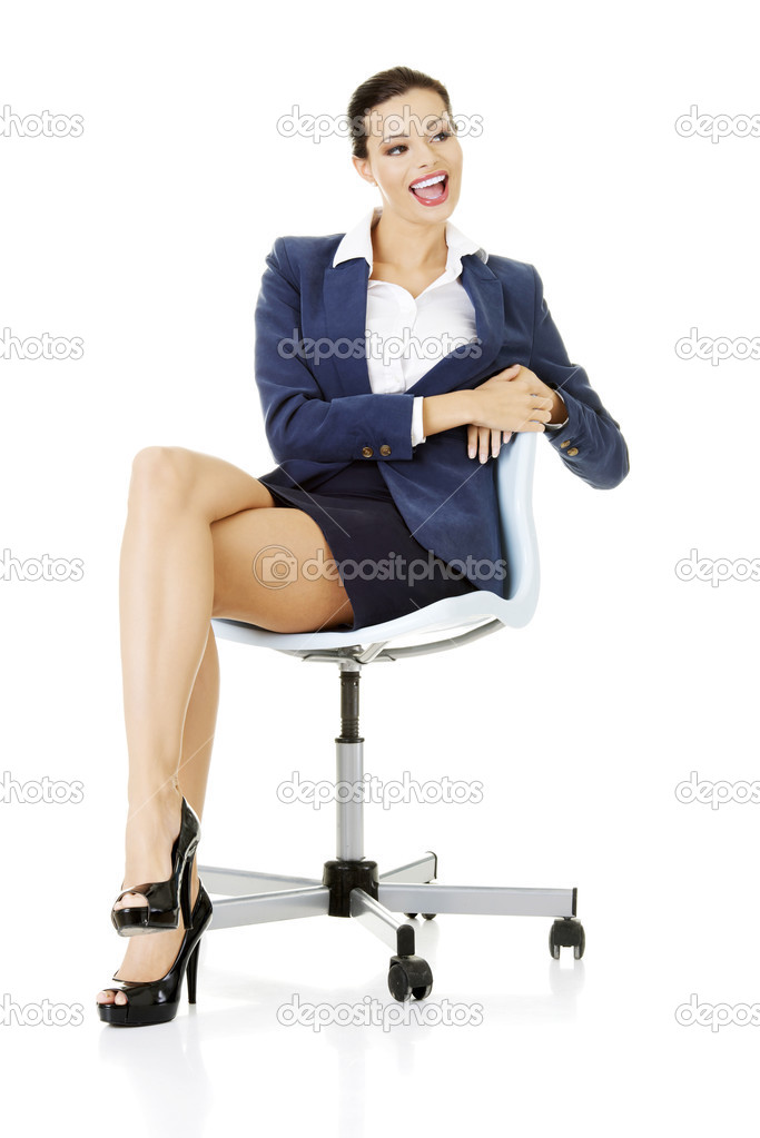 Beautiful successful businesswoman sitting on ofice chair