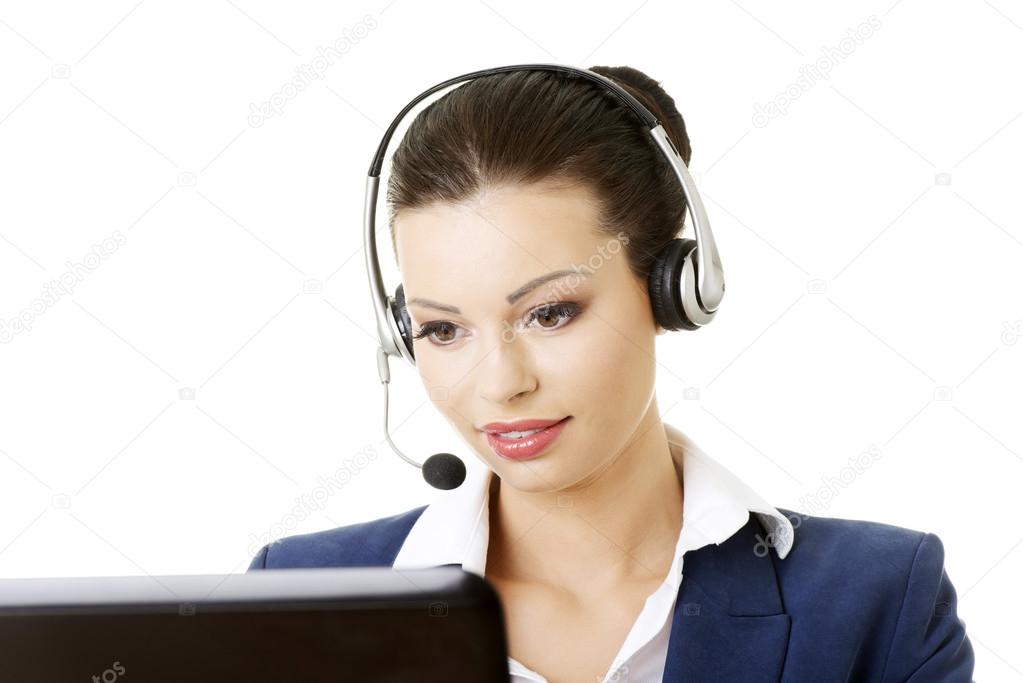 Beautiful young call-center assistant at the desk